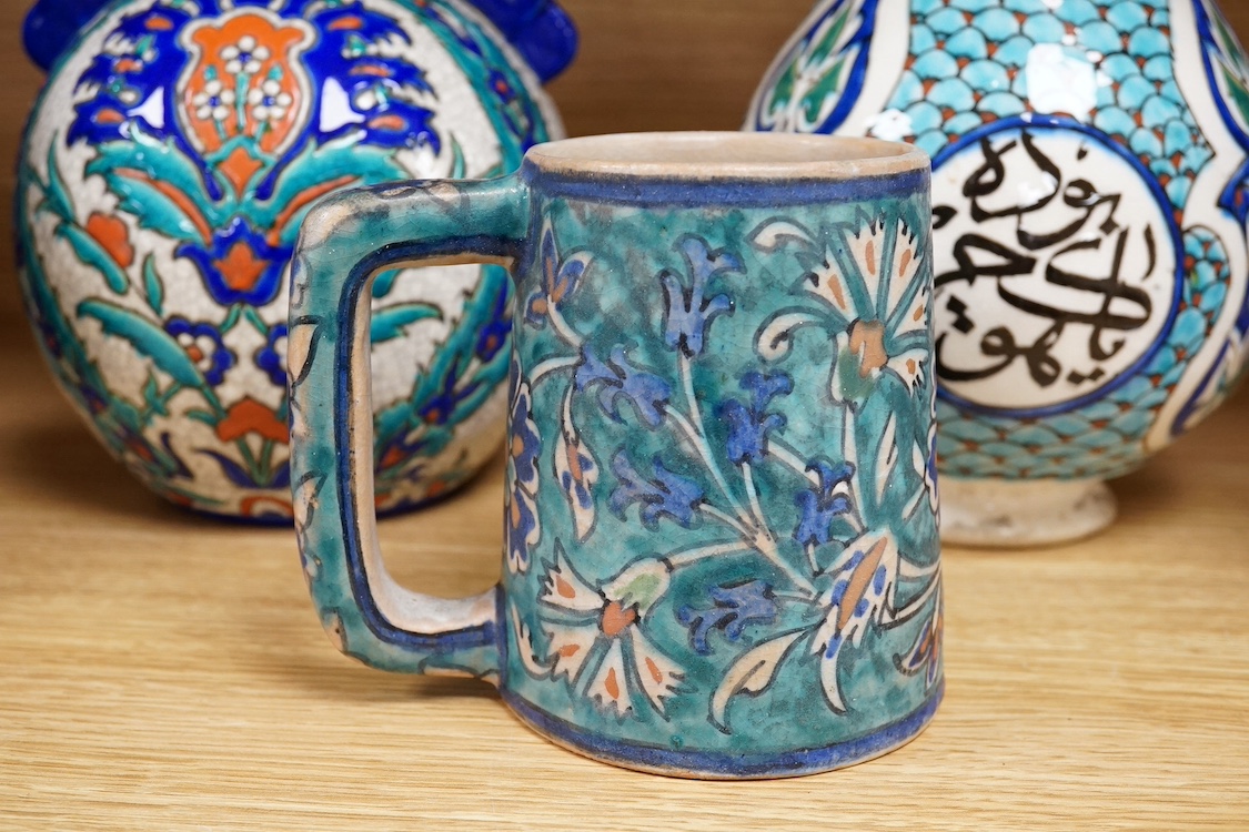 Two Persian vases and a mug, decorated with stylised flowers together with a Laroche Belgium Persian style vase, tallest 28.5cm. Condition - fair to good